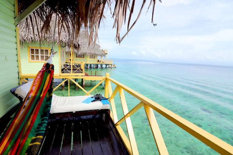 Terrace with a hammock and daybed overlooking the Caribbean Sea