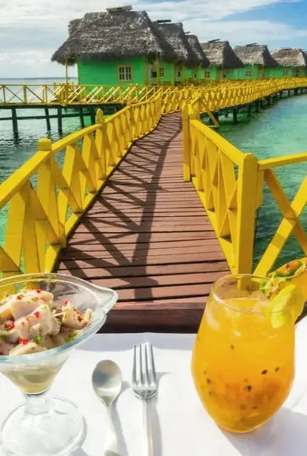 Fresh drink and ceviche on the yellow walkway over the sea