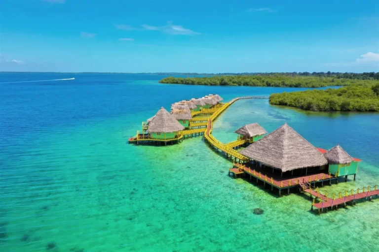 Aerial view of a palafito and its private deck over clear Caribbean water